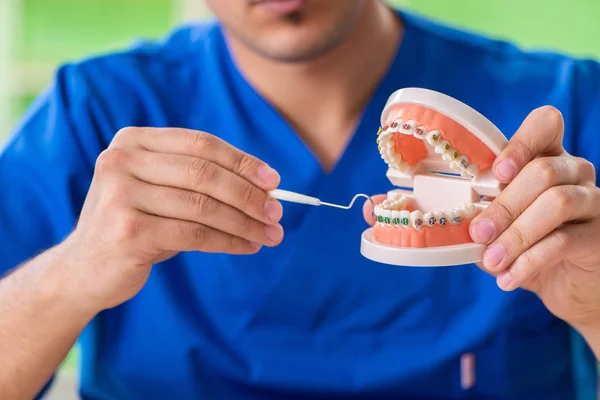 Man dentist working on new teeth implant — Stock Photo, Image