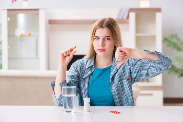 Mujer tomando pastillas para hacer frente al dolor — Foto de Stock