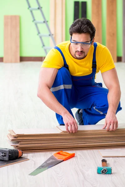 Professional contractor laying flooring at home