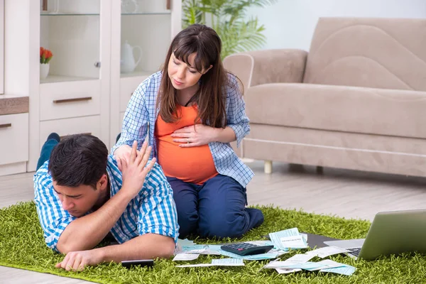 Young family in budget planning concept — Stock Photo, Image