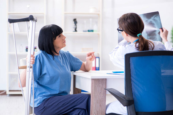 Doctor examining old mature woman after incident