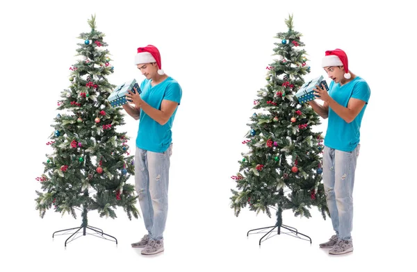 Young man decorating christmas tree isolated on white — Stock Photo, Image