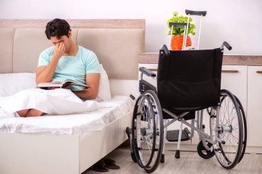 Genç yakışıklı engelli adam evde iyileşiyor. 