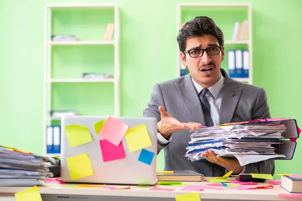 Businessman unhappy with many conflicting priorities sitting in — Stock Photo, Image