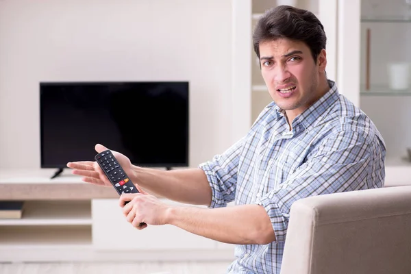 Man trying to fix broken tv