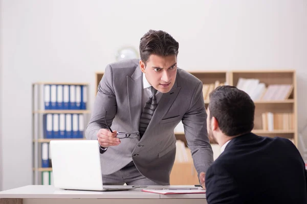 Angry boss shouting at his employee