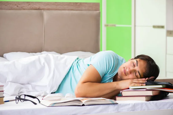 Student preparing for exams at home in bedroom lying on the bed — Stock Photo, Image