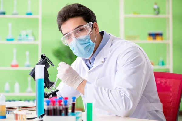 Člověk chemik pracující v laboratoři — Stock fotografie