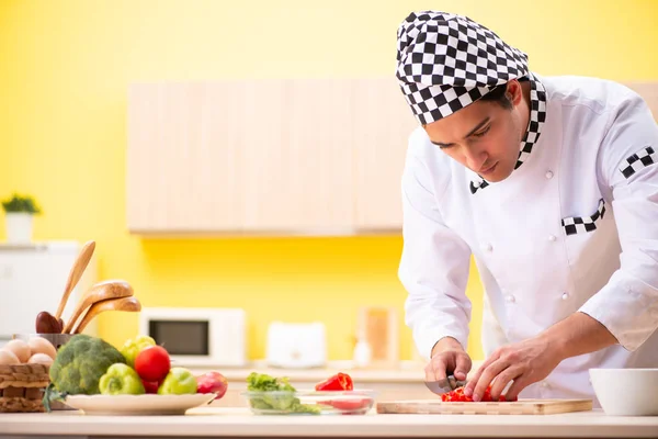 Young professional cook preparing salad at home — Stock Photo, Image