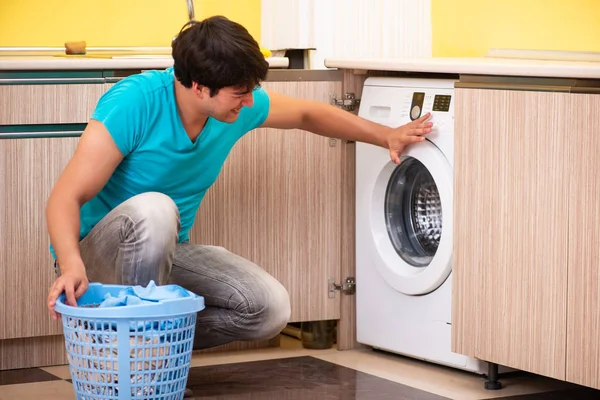 Jeune mari homme faisant la lessive à la maison — Photo