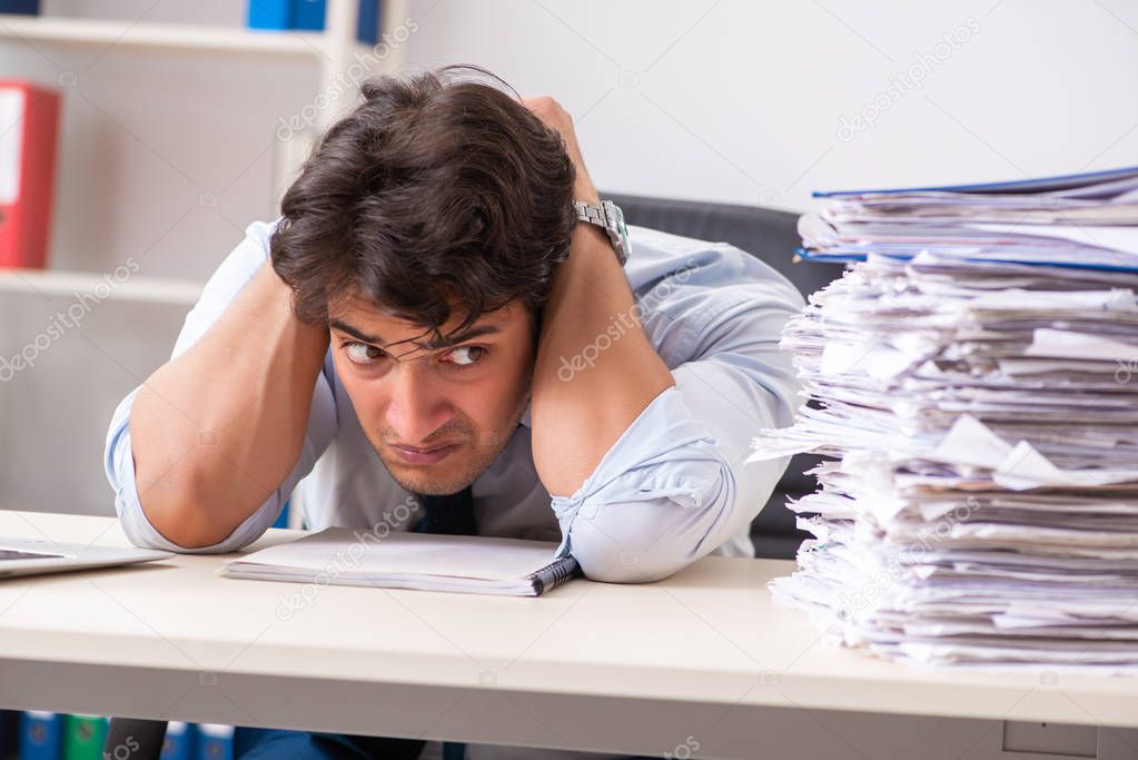 Overloaded busy employee with too much work and paperwork