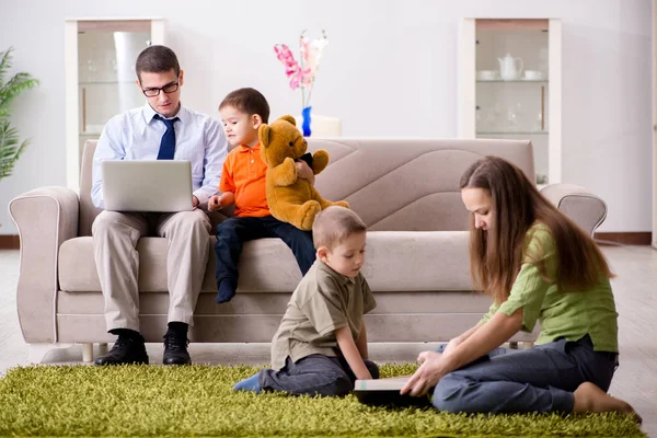 Father is trying to work while children are playing — Stock Photo, Image