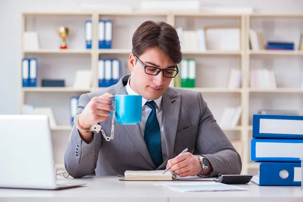 Businessman chained with handcuffs to his coffee — Stock Photo, Image