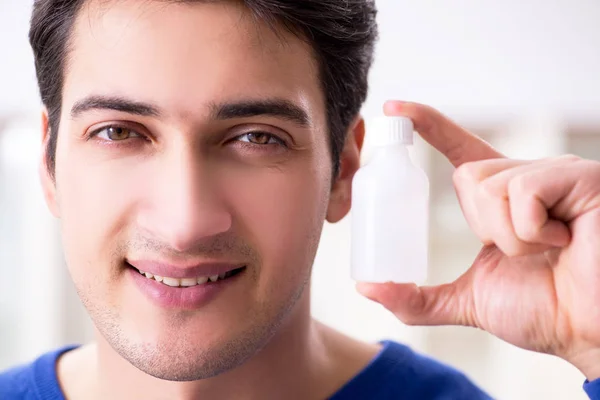Young handsome man taking care of face skin — Stock Photo, Image