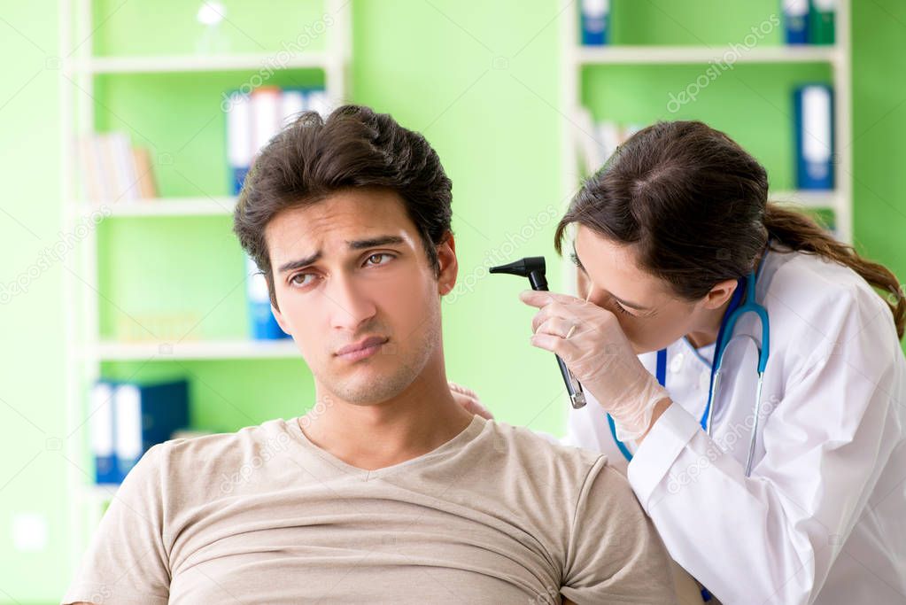 Female doctor checking patients ear during medical examination 