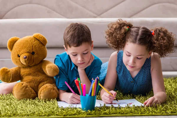 Deux enfants dessinent des images allongées sur la porte — Photo