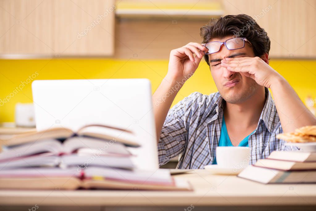 Student preparing for exam sitting at the kitchen 