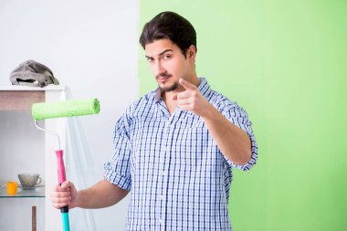 Genç ressam evde tadilat yapıyor. 