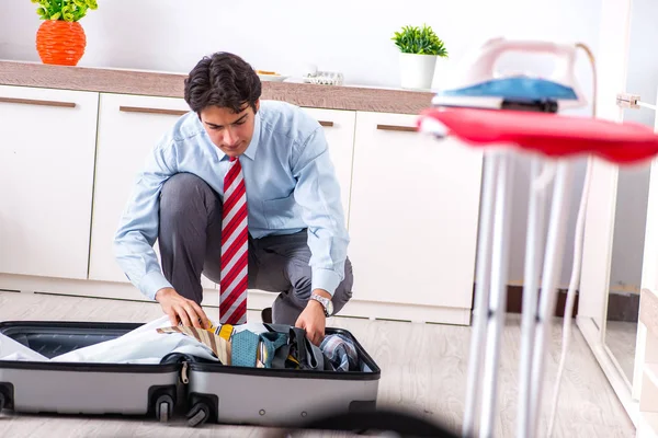 Young handsome businessman preparing for trip — Stock Photo, Image