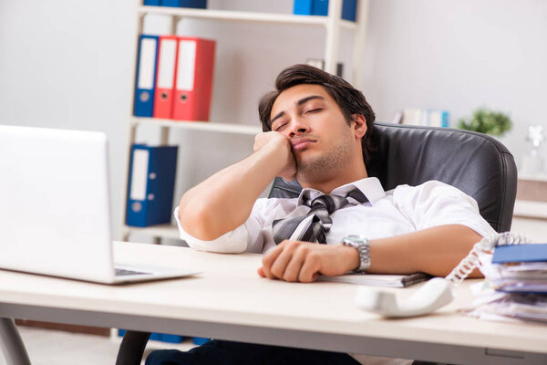 Young handsome businessman working in office