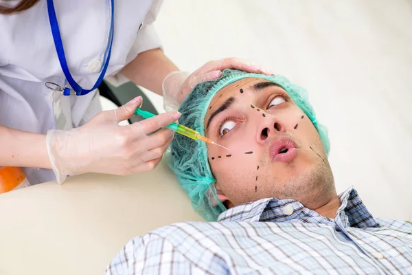 Plastic surgeon preparing for operation on man face — Stock Photo, Image