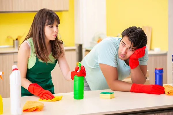 Young couple working at kitchen — Stock Photo, Image