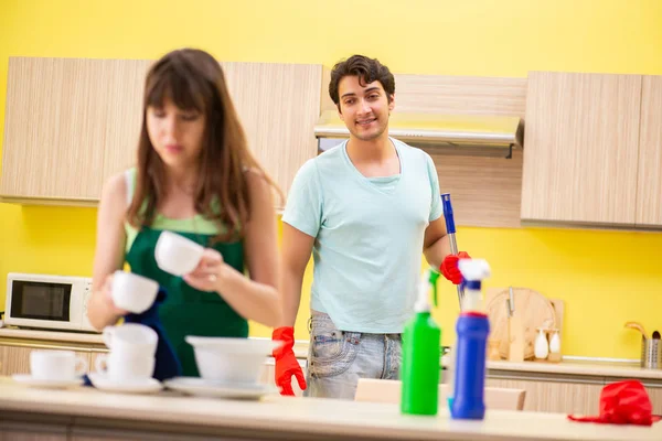 Young couple working at kitchen — Stock Photo, Image