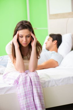 Woman and man in the bedroom after conflict clipart