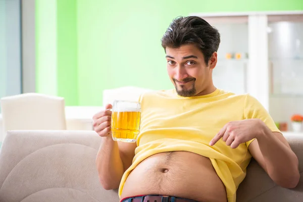 Fat obese man holding beer in dieting concept