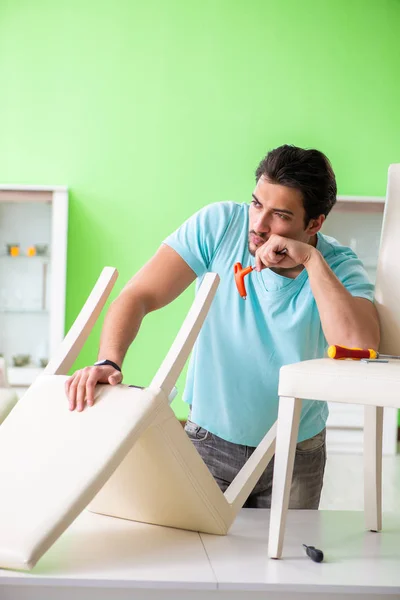 Man repairing furniture at home