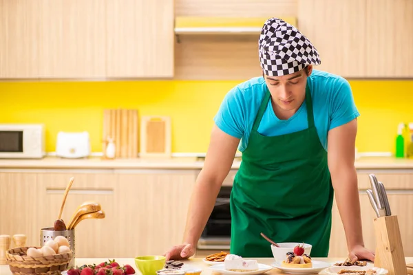 Young professional cook preparing in kitchen — Stock Photo, Image