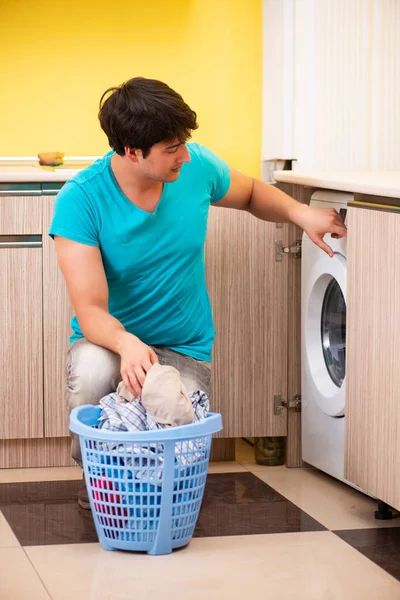Young husband man doing laundry at home — Stock Photo, Image