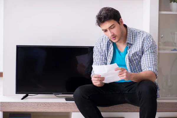 Man trying to fix broken tv