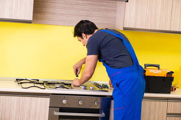 Jovem empreiteiro de serviços montagem de mobiliário de cozinha — Fotografia de Stock