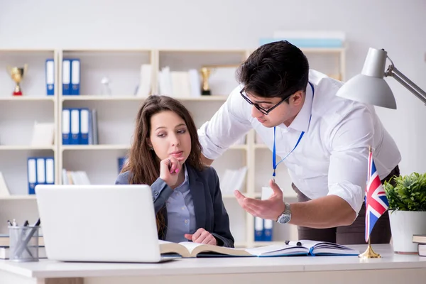 Teacher explaining to student at language training