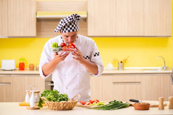 Young professional cook preparing salad at kitchen — Stock Photo, Image