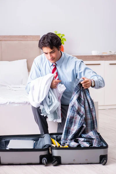 Young handsome businessman preparing for trip — Stock Photo, Image