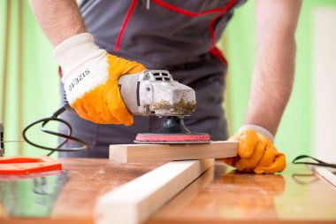 Atölyede çalışan genç bir marangoz. 