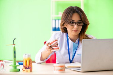 Diş implantı üzerinde çalışan kadın dişçi.