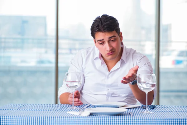 Handsome man alone in restaraunt on date