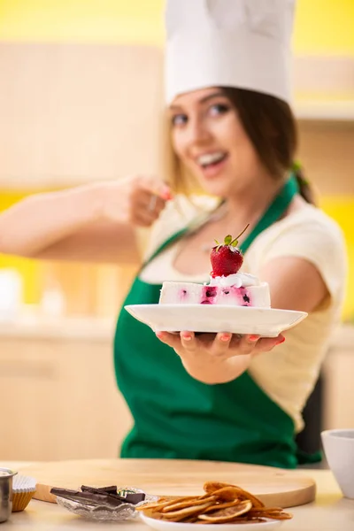 Young cook cooking cakes in the kitchen