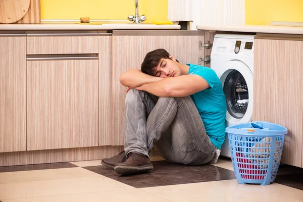 Young husband man doing laundry at home