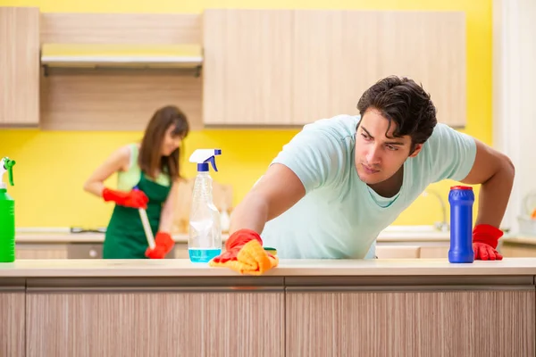 Young couple working at kitchen — Stock Photo, Image