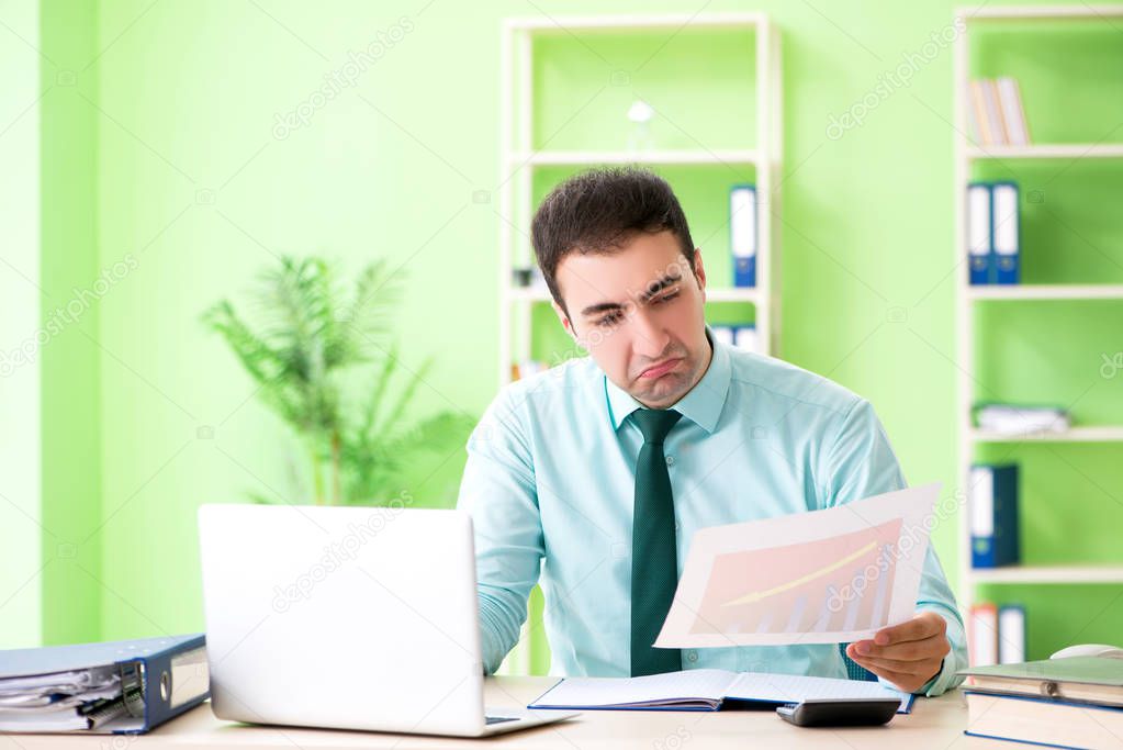 Male financial manager working in the office 