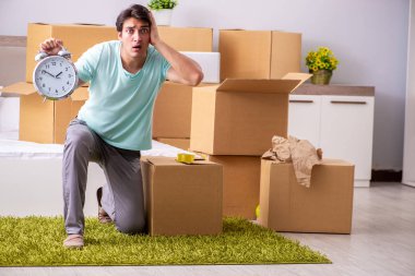 Young man moving to new apartment clipart
