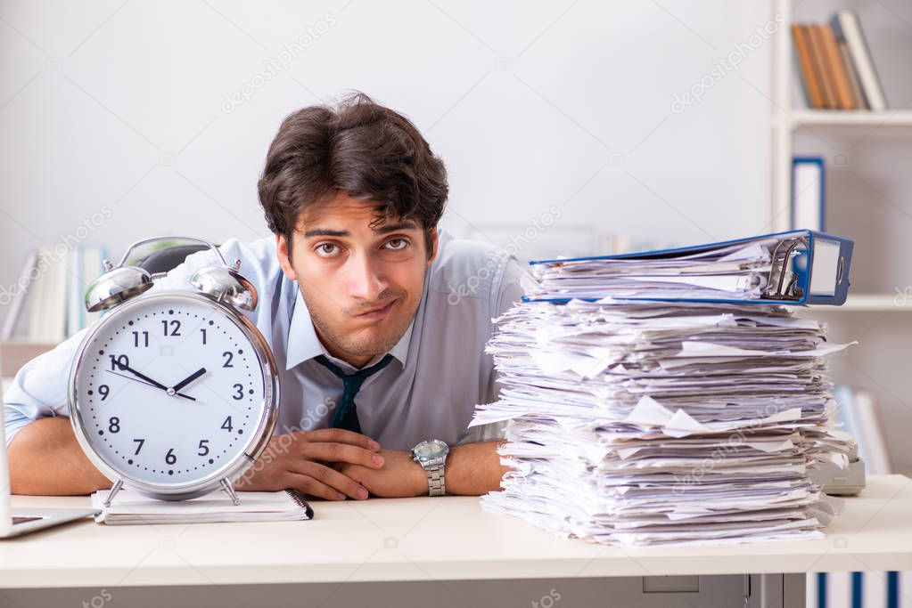 Overloaded busy employee with too much work and paperwork