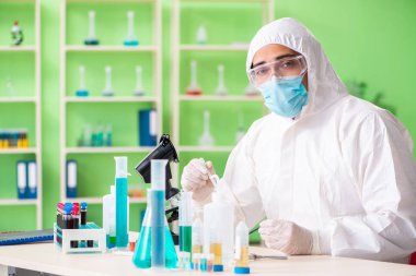 Laboratuvarda yeni bir deney üzerinde çalışan kimyager.