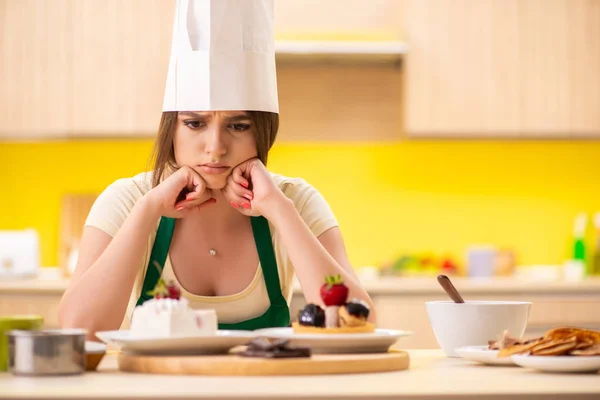 Junge Köchin kocht Kuchen in der Küche — Stockfoto