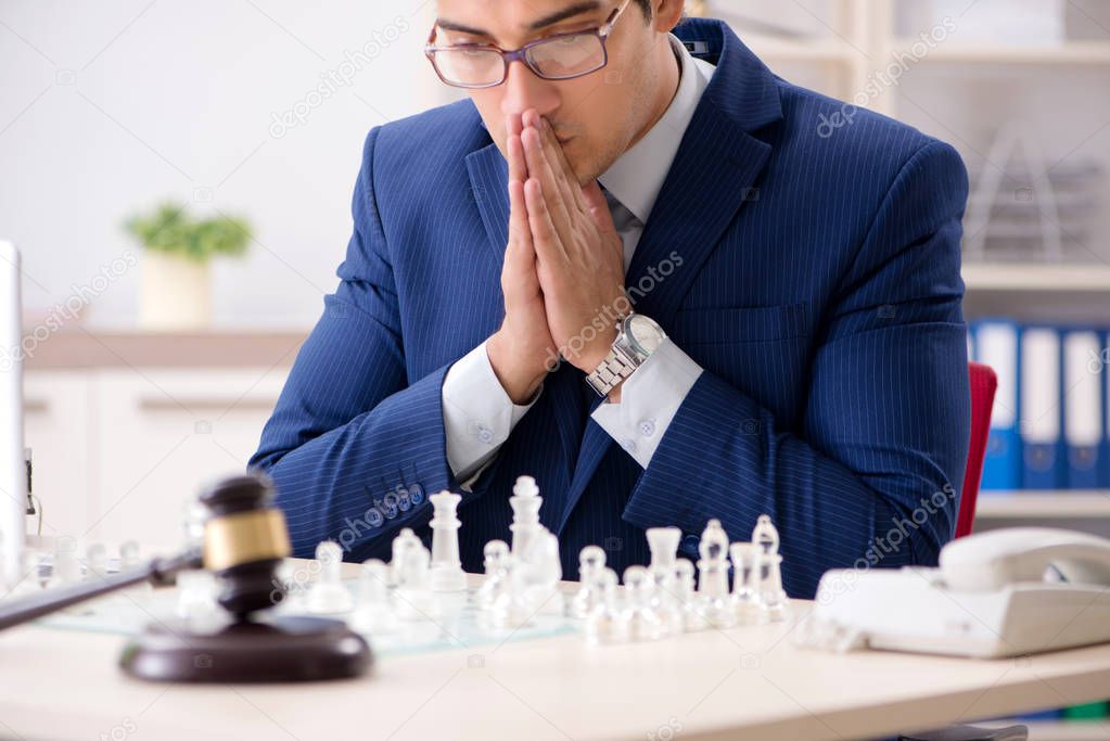 Young lawyer playing chess to train his court strategy and tacti