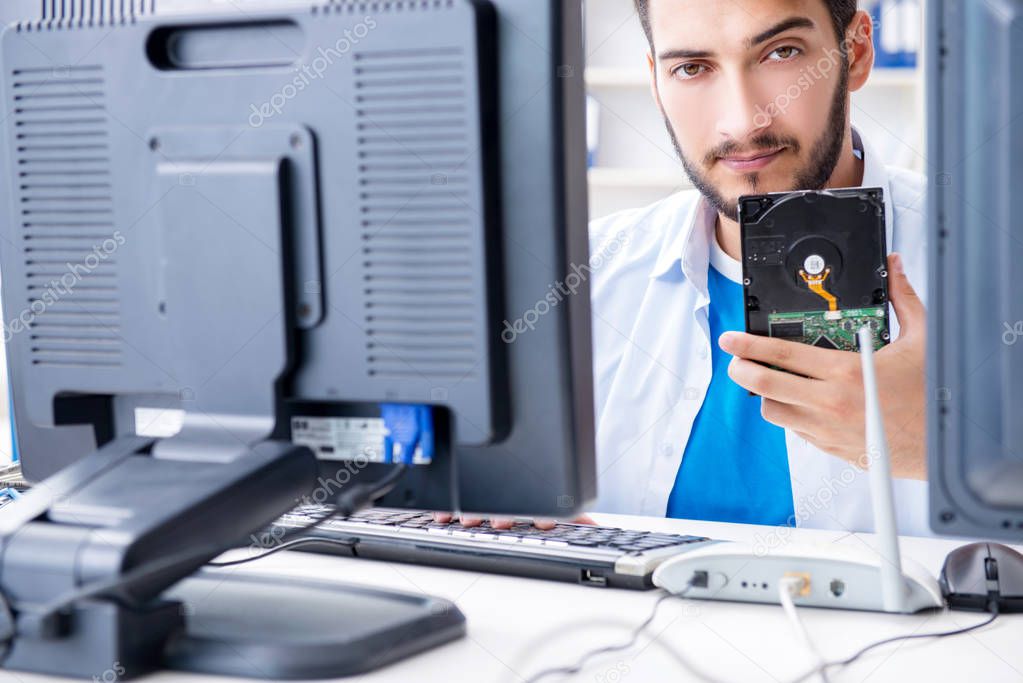 Technician with broken hard drive